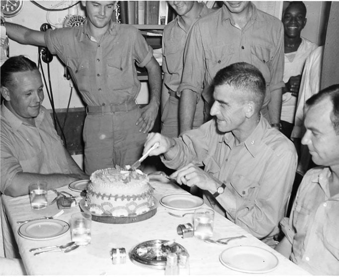 Sailors and Marines cut a slice of good luck cake the night before the raid.U.S. Naval Institute Archives