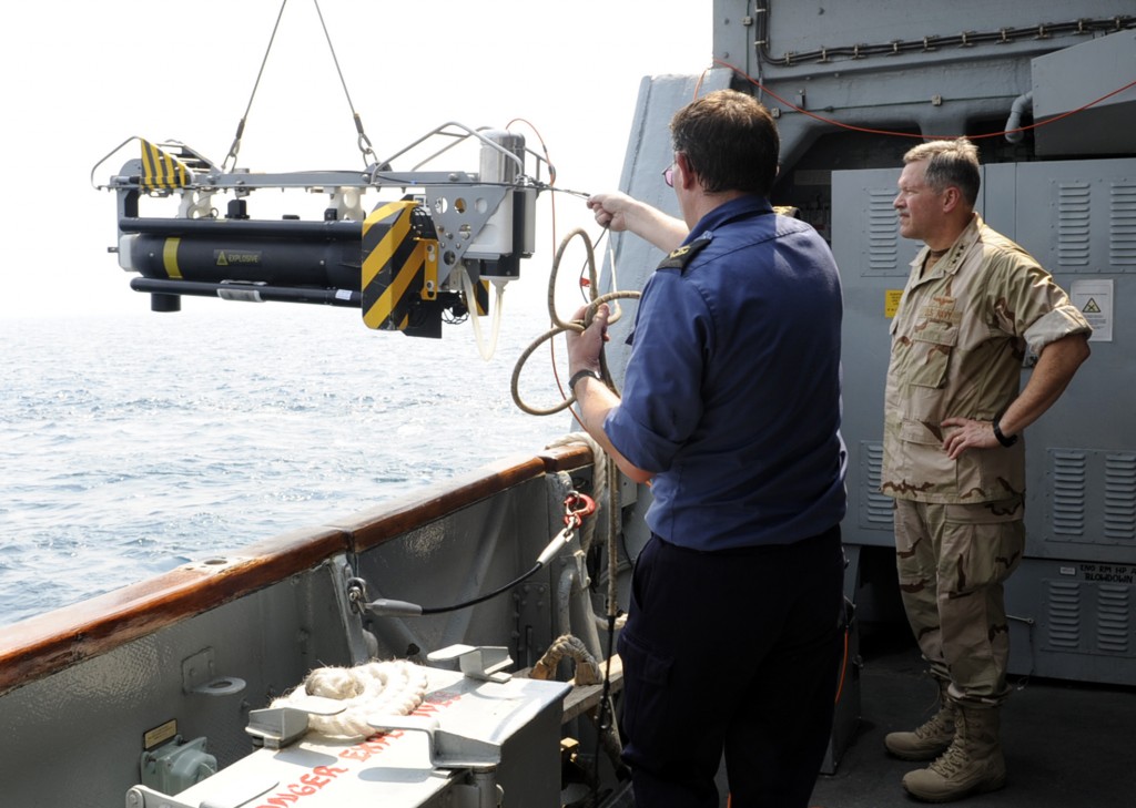 Vice Adm. Mark Fox, right, then commander of U.S. Naval Forces Central Command and Combined Maritime Forces, watches as the crew of the British Royal Navy Hunt-class mine countermeasures vessel HMS Chittingfold (M37) lowers Sea Fox, a mine neutralizer vehicle, into the water in 2010. U.S. Navy photo.