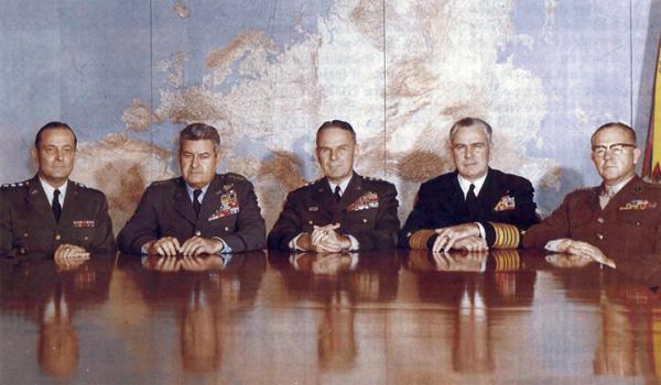 On 1 October, the President appointed Army General Maxwell Taylor, center, to take over for General Lyman Lemnitzer as chairman of the Joint Chiefs of Staff. Taylor had been serving in the White House as military representative to the President. Flanking Taylor, left to right, are Army Chief of Staff General Earle Wheeler, Air Force Chief of Staff General Curtis LeMay, Chief of Naval Operations Admiral George Anderson, and Commandant of the Marine Corps General David Shoup. Navy History and Hertigae Command