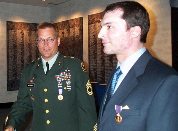 Author receiving the Purple Heart in a April 26, 2002 ceremony with U.S. Army Sgt. 1st Class Steve Workman. Sgt. 1st Class Workman transported the author to one of the first ambulances that arrived on the scene after the crash. U.S. Army photo