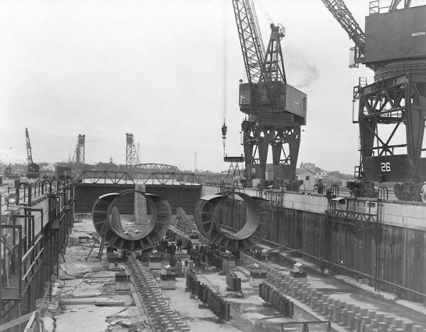 Pressure-hull sections in a submarine basin at the Portsmouth Navy Yard in March 1943. The shipyard had developed and refined sectional construction in the years leading up to World War II, and when war came the yard was poised to capitalize on a sudden surge in demand and the need for mass-production methods, University of New Hampshire Library.
