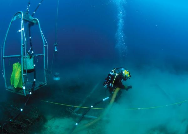 Navy Diver assigned to Mobile Diving and Salvage Unit (MDSU) 2, Company 4, operates a suction dredge system during an underwater recovery operation in search of a missing service member on 6 October in the Mediterranean Sea. U.S. Navy
