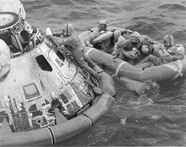 Decontaminating the Apollo 11 command module as the astronauts wait to be recovered, July 24, 1969. US Naval Institute Archives
