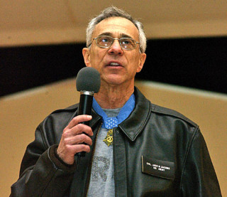 Jack Jacobs, retired U.S. Army colonel and Medal of Honor recipient, adresses forward deployed troops at a USO event in 2005. US Air Force Photo