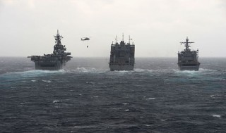 USNS Robert E. Peary (T-AKE 5), center, conducts a dual replenishment-at-sea with the amphibious assault ship USS Kearsarge (LHD 3) and the amphibious landing dock ship USS Carter Hall (LSD 50) on Feb 13. US Navy Photo 