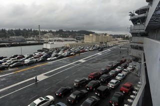 Sailors' vehicles are parked on the flight deck of the aircraft carrier USS Ronald Reagan (CVN-76) on March, 13 2013. US Navy Photo 