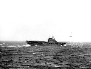 A B-25 taking off from flight deck of USS Hornet (CV-8) which is carrying a load of Army planes for raid on Tokyo as seen from USS Enterprise (CV-6). 18 April, 1942. US Naval Institute Photo