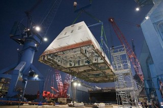 The deckhouse of the future destroyer USS Zumwalt (DDG 1000) is craned toward the deck of the ship to be integrated with the ship's hull at General Dynamics Bath Iron Works. US Navy Photo