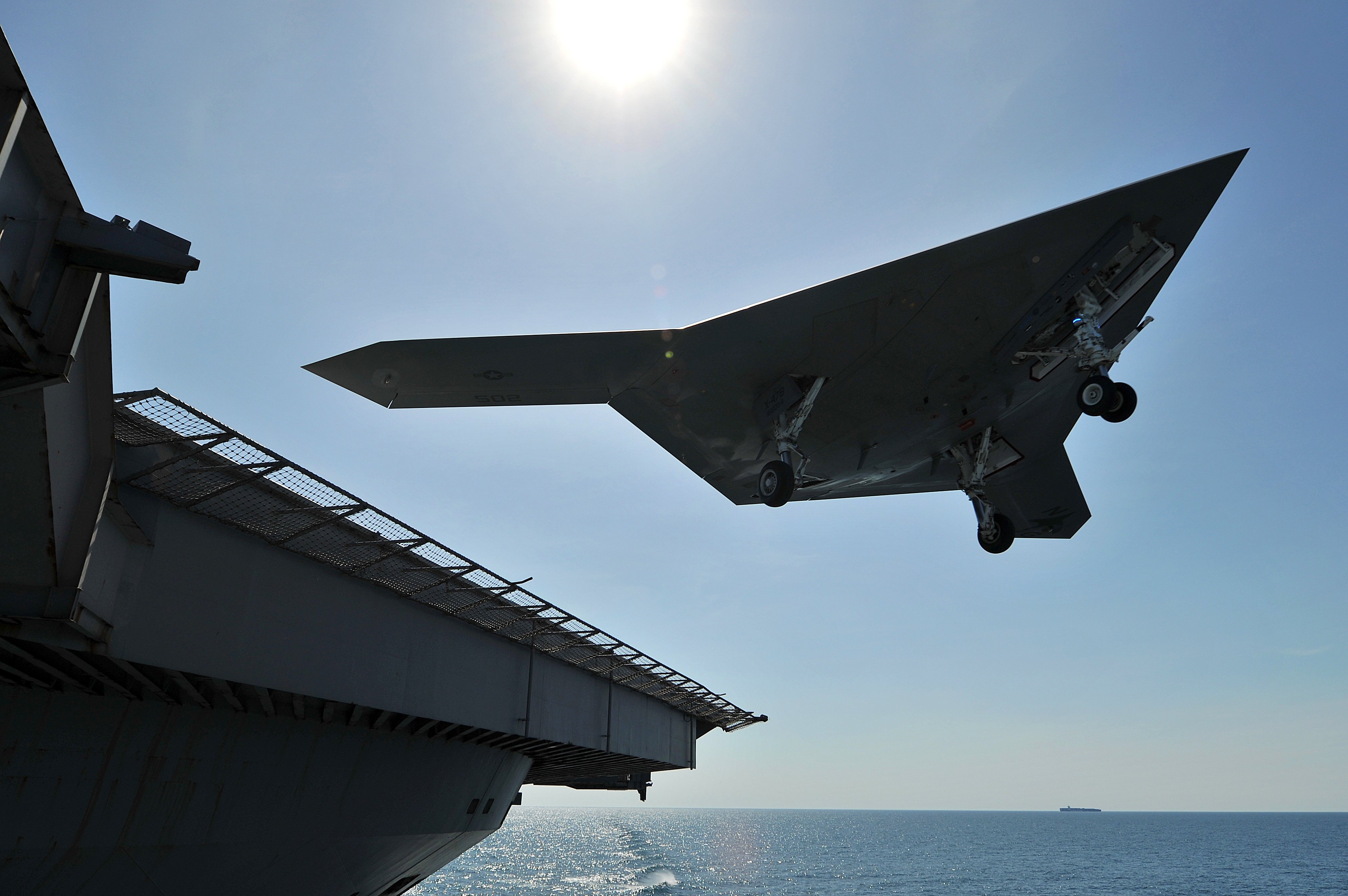 An X-47B Unmanned Combat Air System (UCAS) demonstrator conducts a touch and go landing on the flight deck of the aircraft carrier USS George H.W. Bush (CVN-77). US Navy Photo