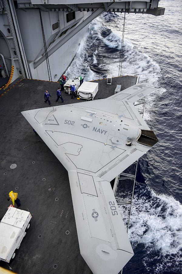 An X-47B Unmanned Combat Air System (UCAS) demonstrator aircraft is transported on an aircraft elevator aboard the aircraft carrier Harry S. Truman (CVN-75). US Navy Photo