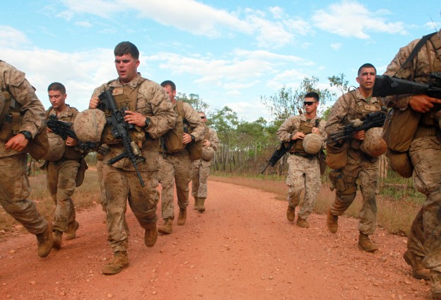 Marines with 1st Platoon, Lima Company, 3rd Battalion, 3rd Marine Regiment, Marine Rotational Force - Darwin, sprint to their first station wearing full gear during a squad competition on May, 23 2013. US Marine Corps Photo