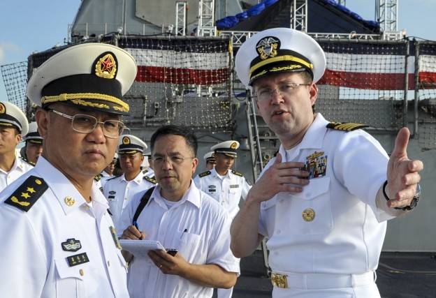 Capt. James T. Jones, commanding officer of the Ticonderoga-class guided-missile cruiser USS Shiloh (CG 67), right, describes his ship to Commander of People’s Liberation Army (PLA) Navy’s South Sea Fleet (SSF), Vice Adm. Jiang Weilie in May. U.S. Navy Photo