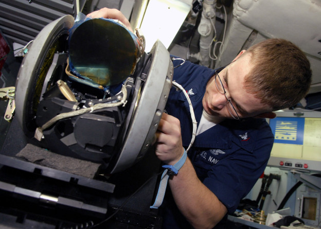 A sailor repairs a forward looking infrared pod (AT FLIR) in 2007. US Navy Photo