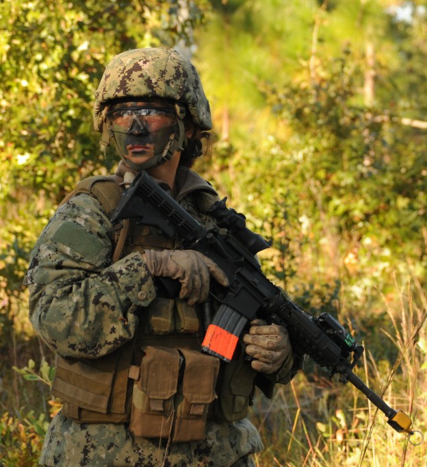 Chief Engineman Patricia Cooper, a student in the Riverine Combat Skills course (RCS), patrols the training grounds during a field training exercise in Camp Lejeune, N.C. in 2012. US Navy Photo