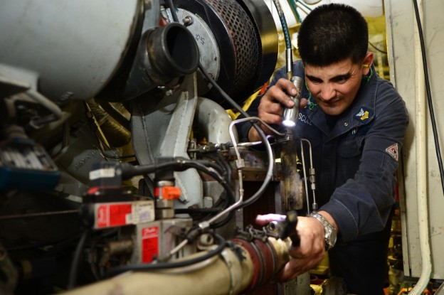  A sailor troubleshoots a ship's service diesel generator aboard the Freedom on July 20. US Navy Photo