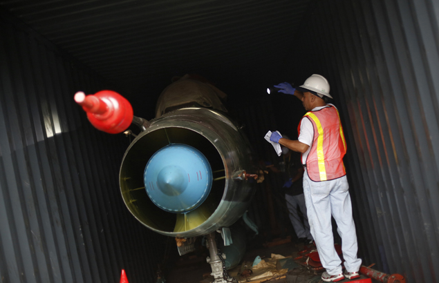 Panamaniain investigators inspect a Cuban MiG 21 found hidden on a North Korean merchant vessel on July 21, 2013. REUTERS Photo