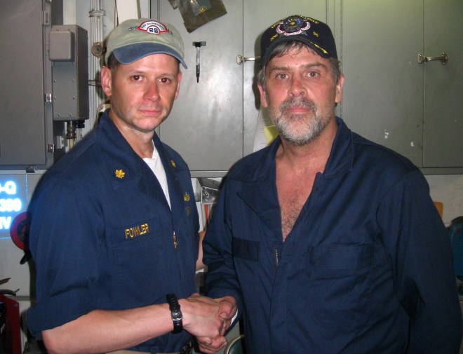 Maersk-Alabama Capt. Richard Phillips, stands alongside Lt. Cmdr. David Fowler, commanding officer of USS Bainbridge (DDG 96) after being rescued by US Naval Forces off the coast of Somalia on April 12, 2009. US Navy Photo