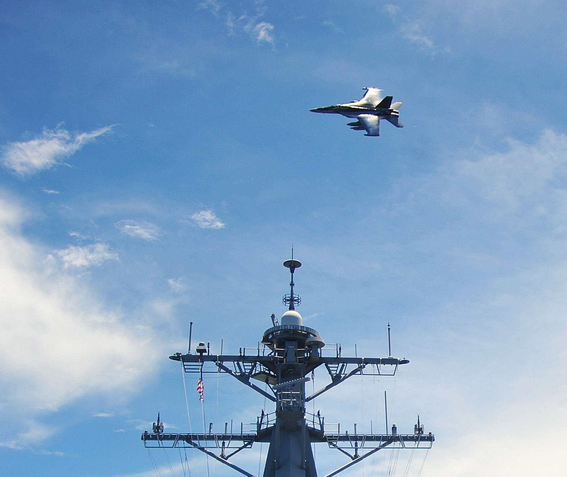 EA-18G Growler assigned to the Electronic Attack Squadron 141 (VAQ) flies over the Arleigh Burke-class guided-missile destroyer USS McCampbell (DDG-85) on Sept. 3, 2012 