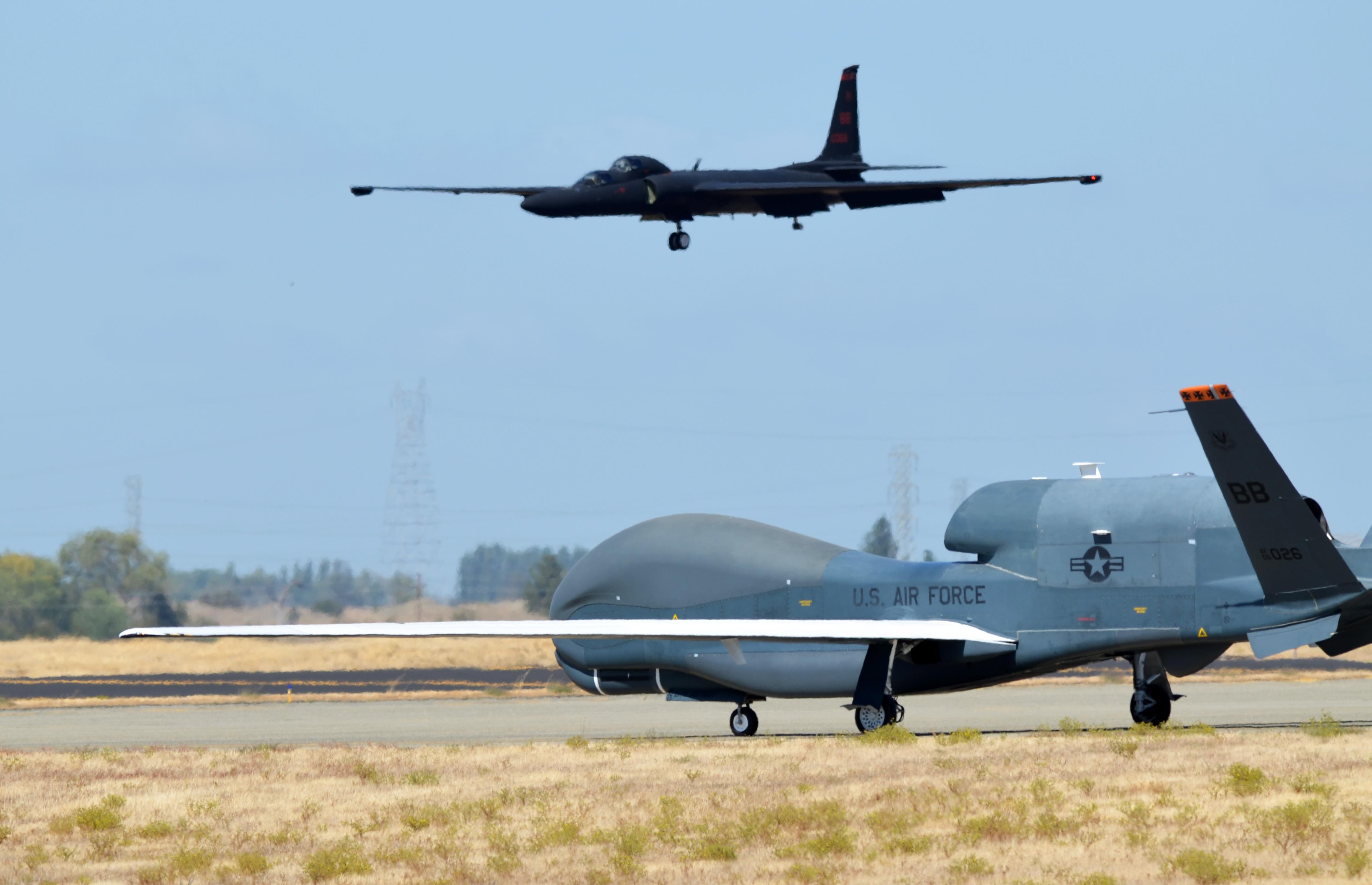 An RQ-4 Global Hawk taxies on the flightline as a U-2 makes its final approach Sept. 17, 2013, at Beale Air Force Base, Calif. US Air Force Photo