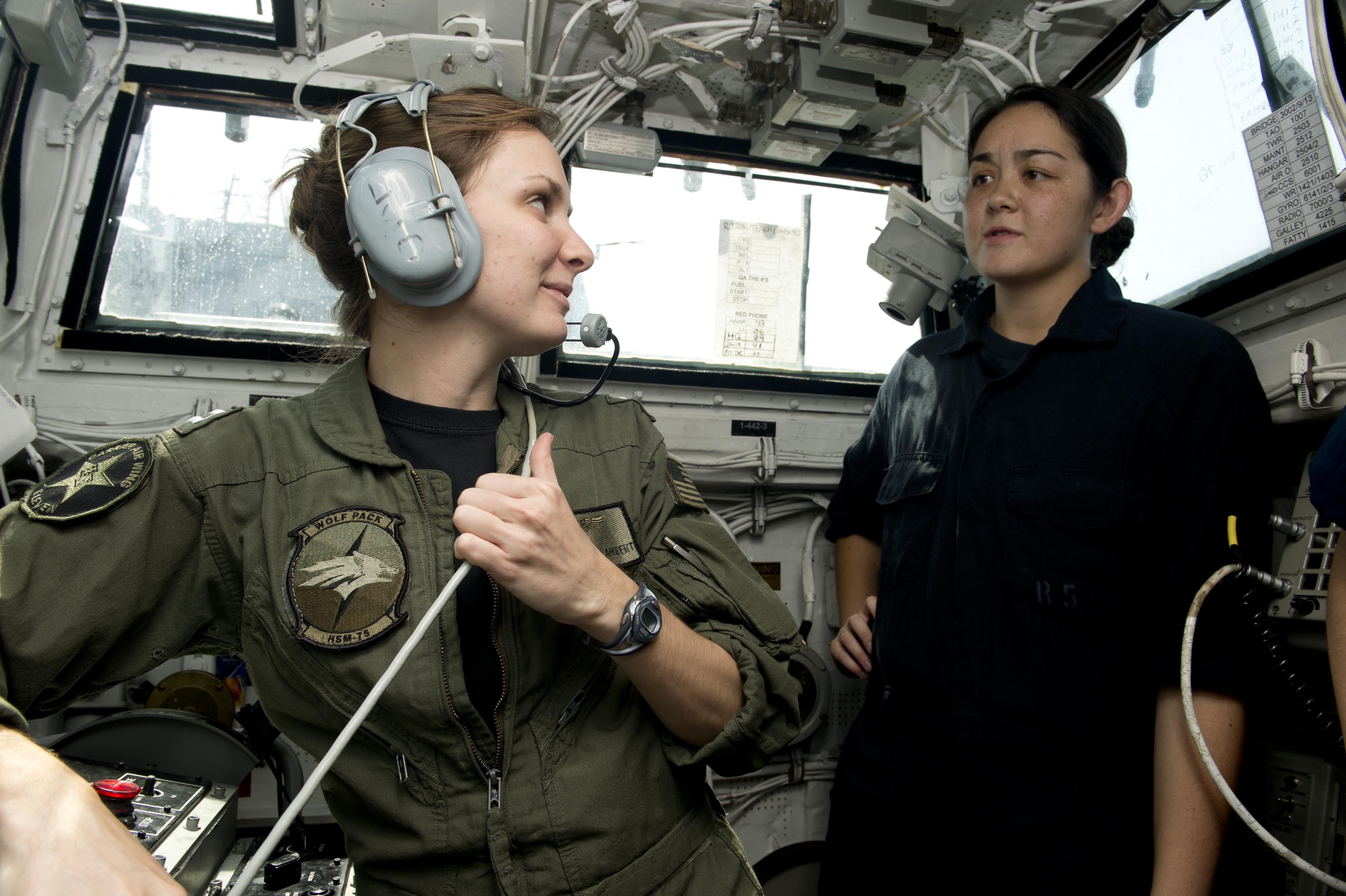 Lt. Brittny Lambert talks to a midshipman about flight operations in the landing signal officer shack aboard the guided-missile destroyer USS William P. Lawrence (DDG-110). US Navy Photo