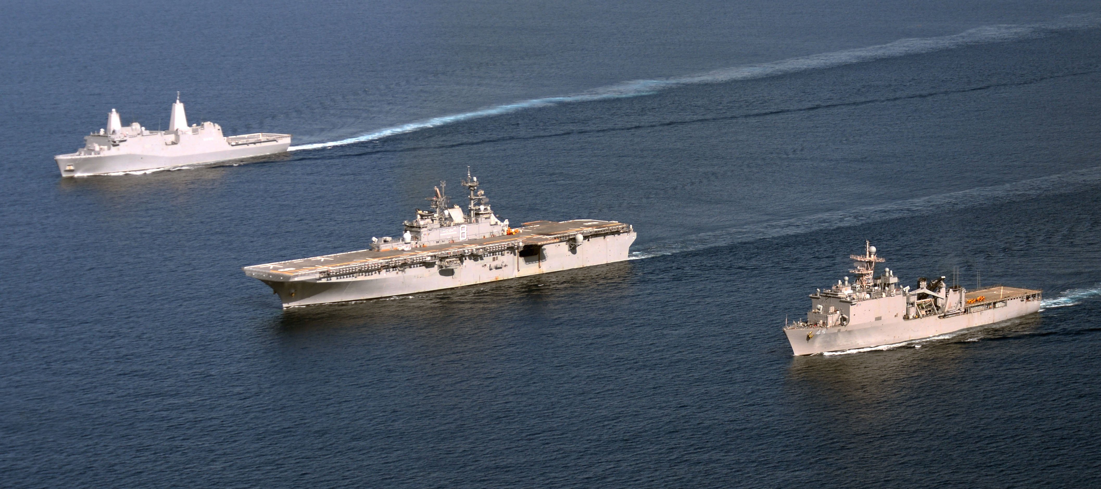 USS Makin Island (LHD-8), alongside the dock landing ship USS Comstock (LSD-45), right, and the amphibious transport dock ship USS San Diego (LPD-22) on March 14, 2014. US Navy Photo