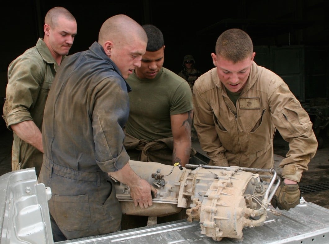  Marines with Combat Logistics Company, Combat Logistics Battalion 7 work together to put a transmission in the back of one of their vehicles aboard Camp Shorabak, Helmand province, Afghanistan on March 12, 2014. US Marine Corps Photo