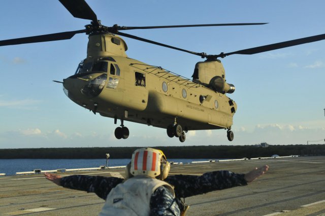 A US Army CH-47 Chinook lands on the USS Tarawa (LHA-1) during deck qualification in the Pacific Ocean, July 19, 2013. US Army Photo