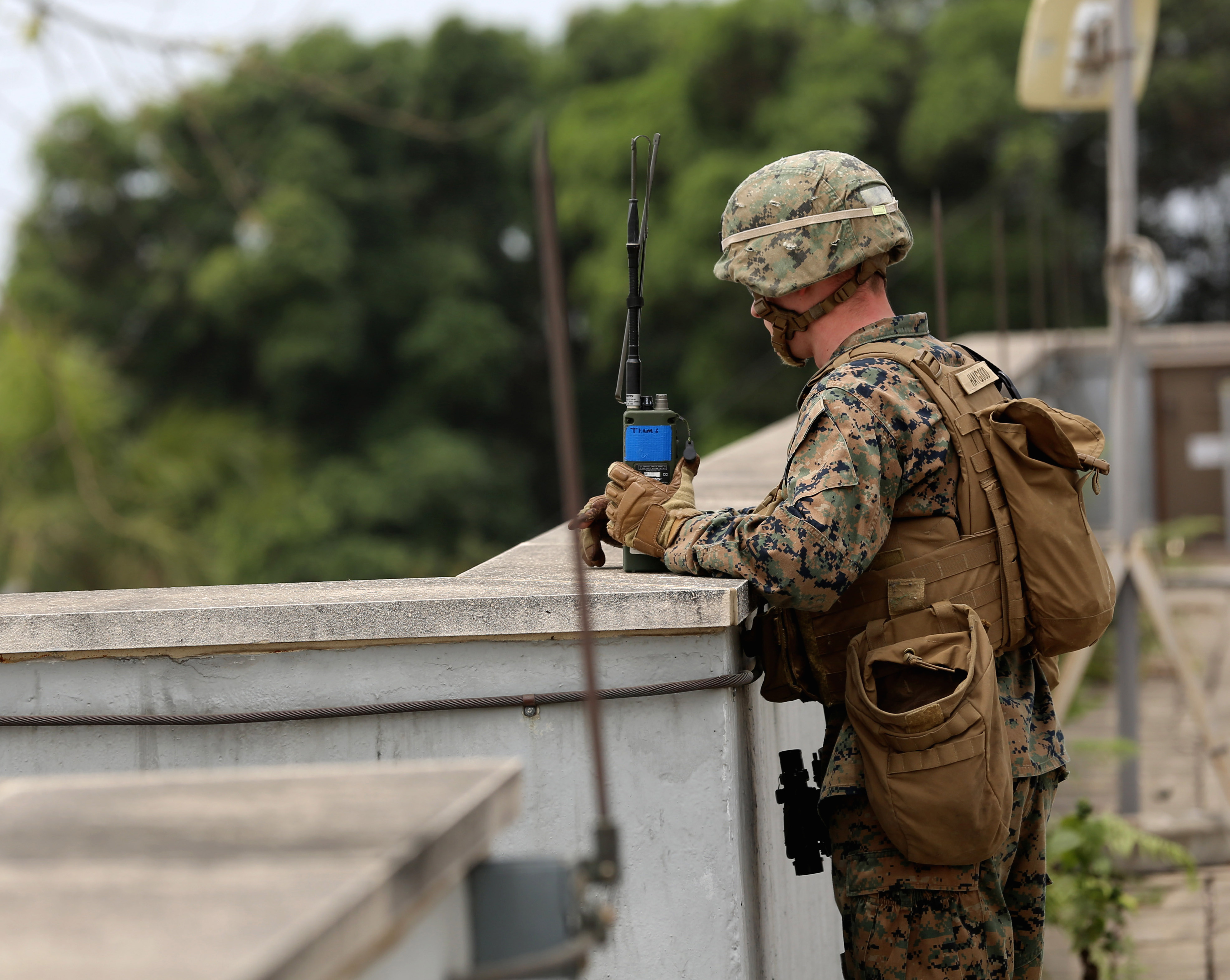 A Marine provides an over watch for Marines conducting vehicle inspections at the American Embassy in Monrovia, Liberia, during a training exercise March 7, 2014. US Marine Corps Photo