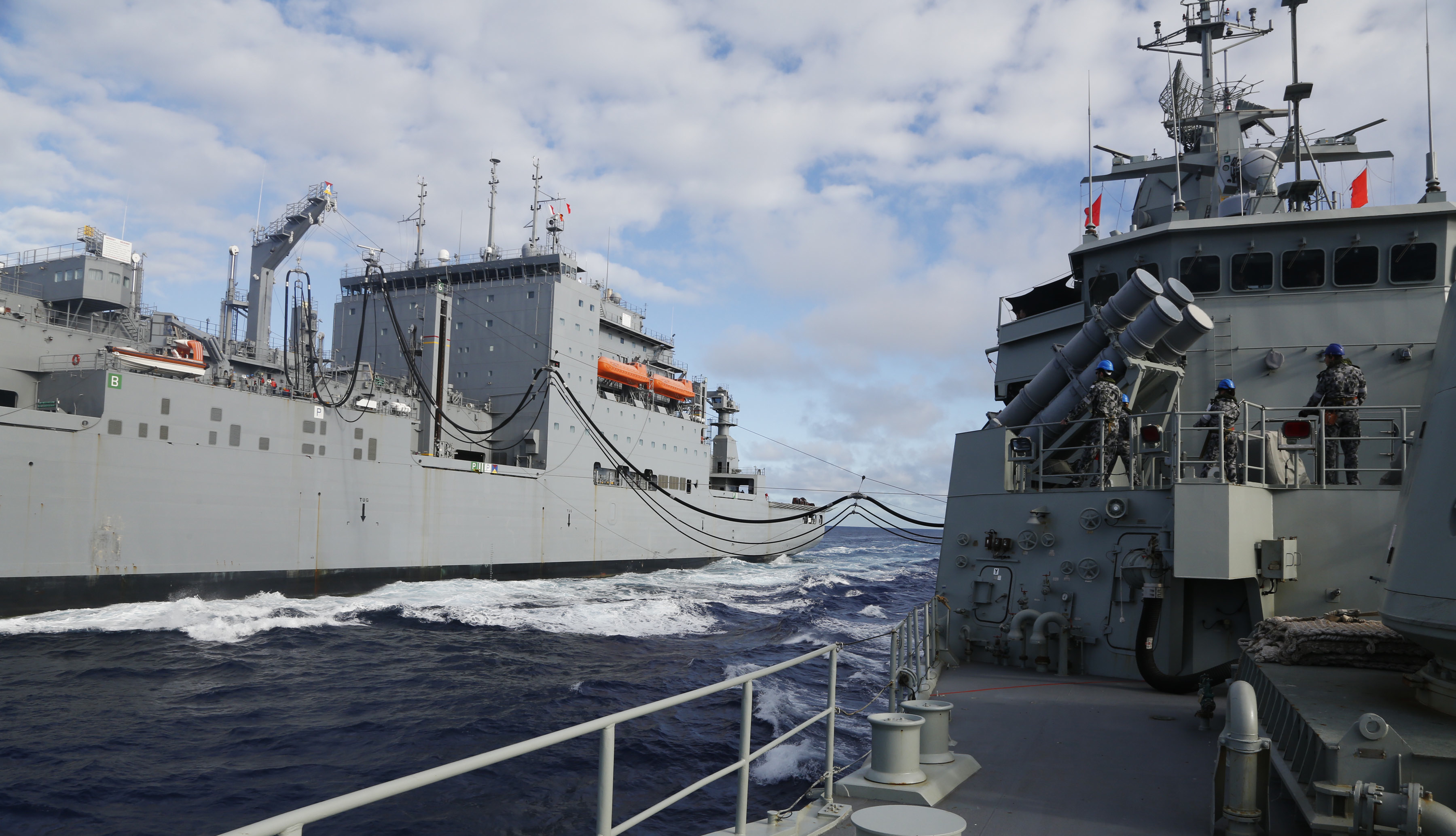 USNS Cesar Chavez (T-AKE 14) refuels the Royal Australian Navy frigate HMAS Perth (III) on April 12. US Navy Photo