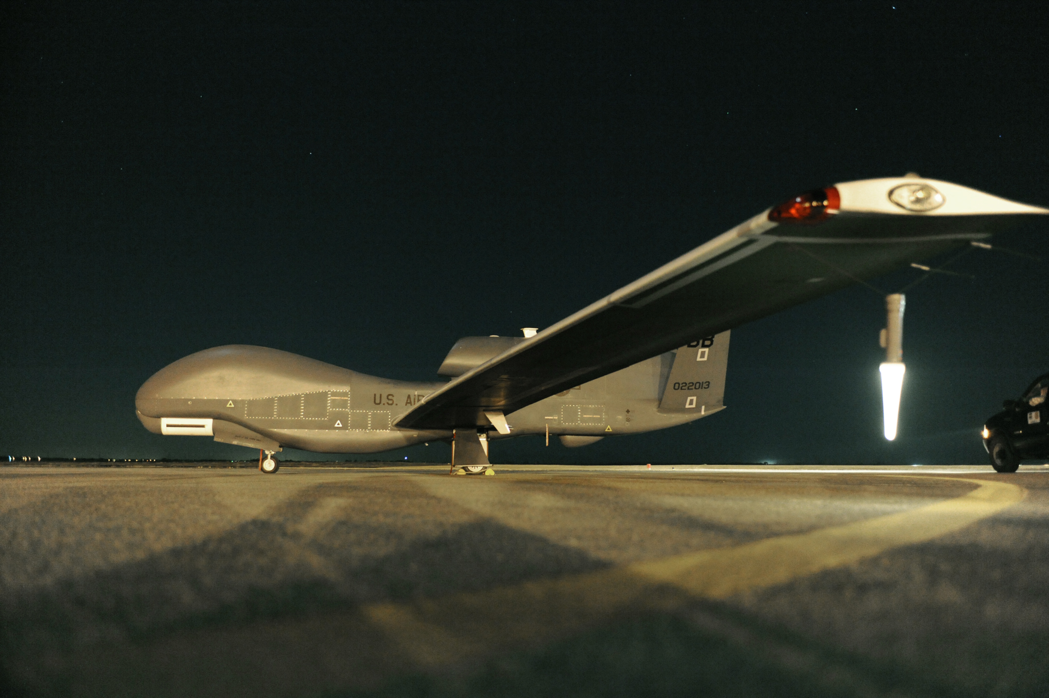 RQ-4 Global Hawk sits on the runway before beginning a nighttime mission. US Air Force Photo