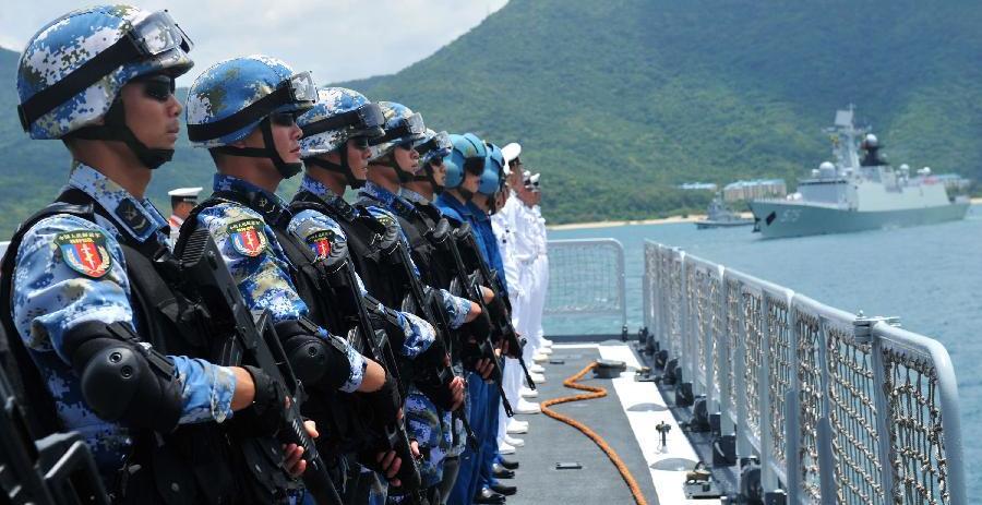 Members of a special battle force stand on China's missile destroyer Haikou at a naval port in Sanya, south China's Hainan Province, June 9, 2014. Xinhua Photo