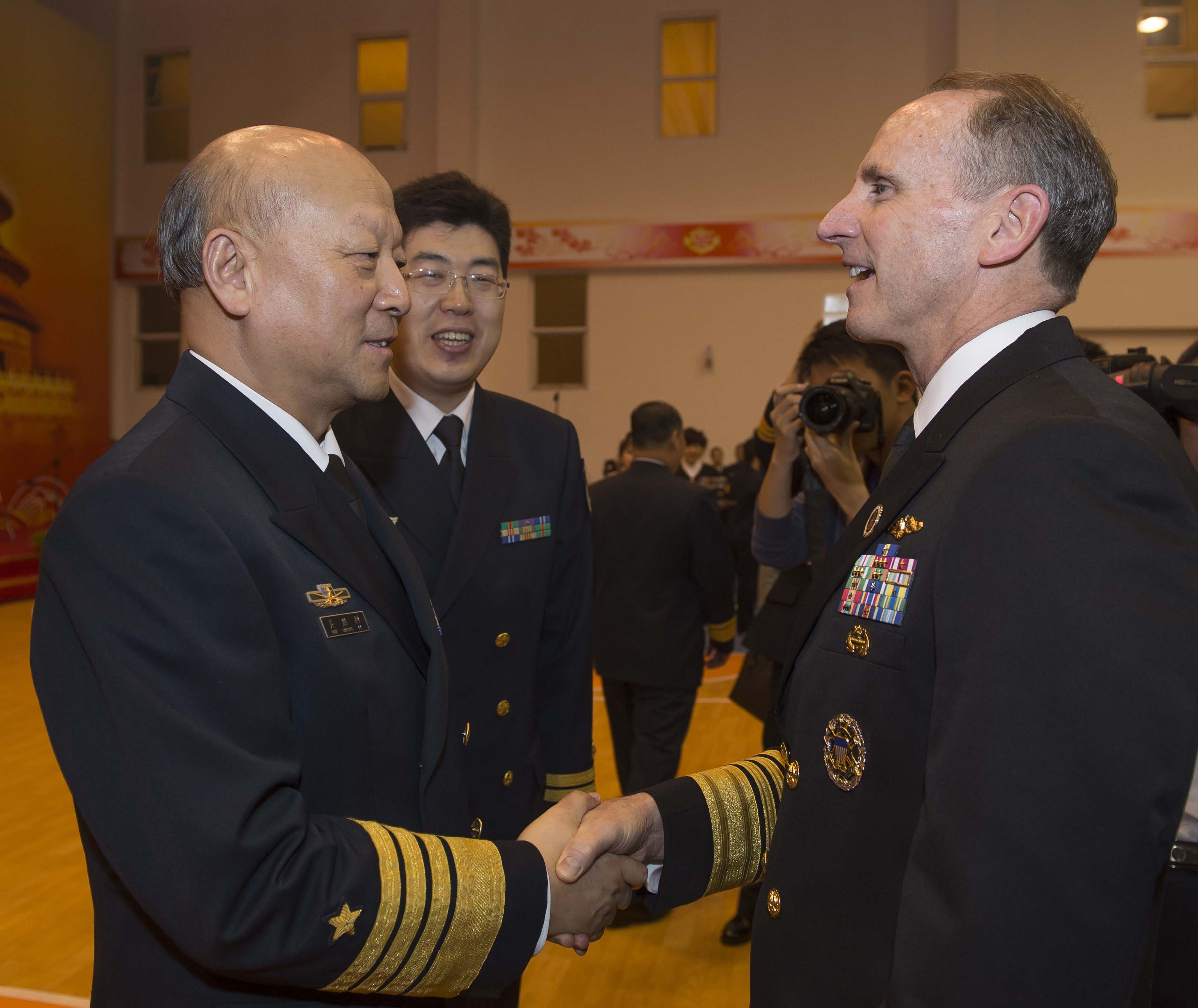 Chief of Naval Operations (CNO) Adm. Jonathan Greenert and Chief of Navy of the People's Liberation Army Navy (PLAN) Adm. Wu Shengli greet each other in Qingdao, China on April 21, 2014. US Navy Photo