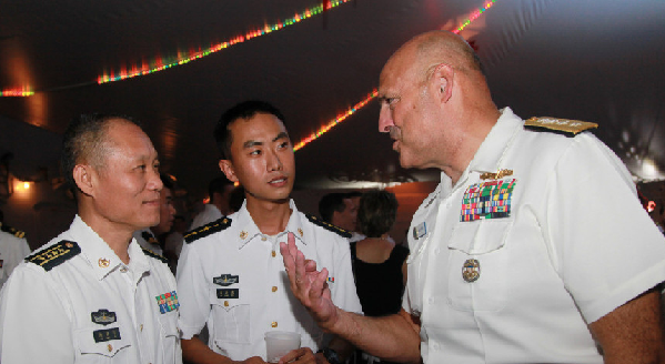 People's Liberation Army Navy officers with a U.S. officer on a Chinese warship in Hawaii, June 28, 2014. PLA Daily Photo