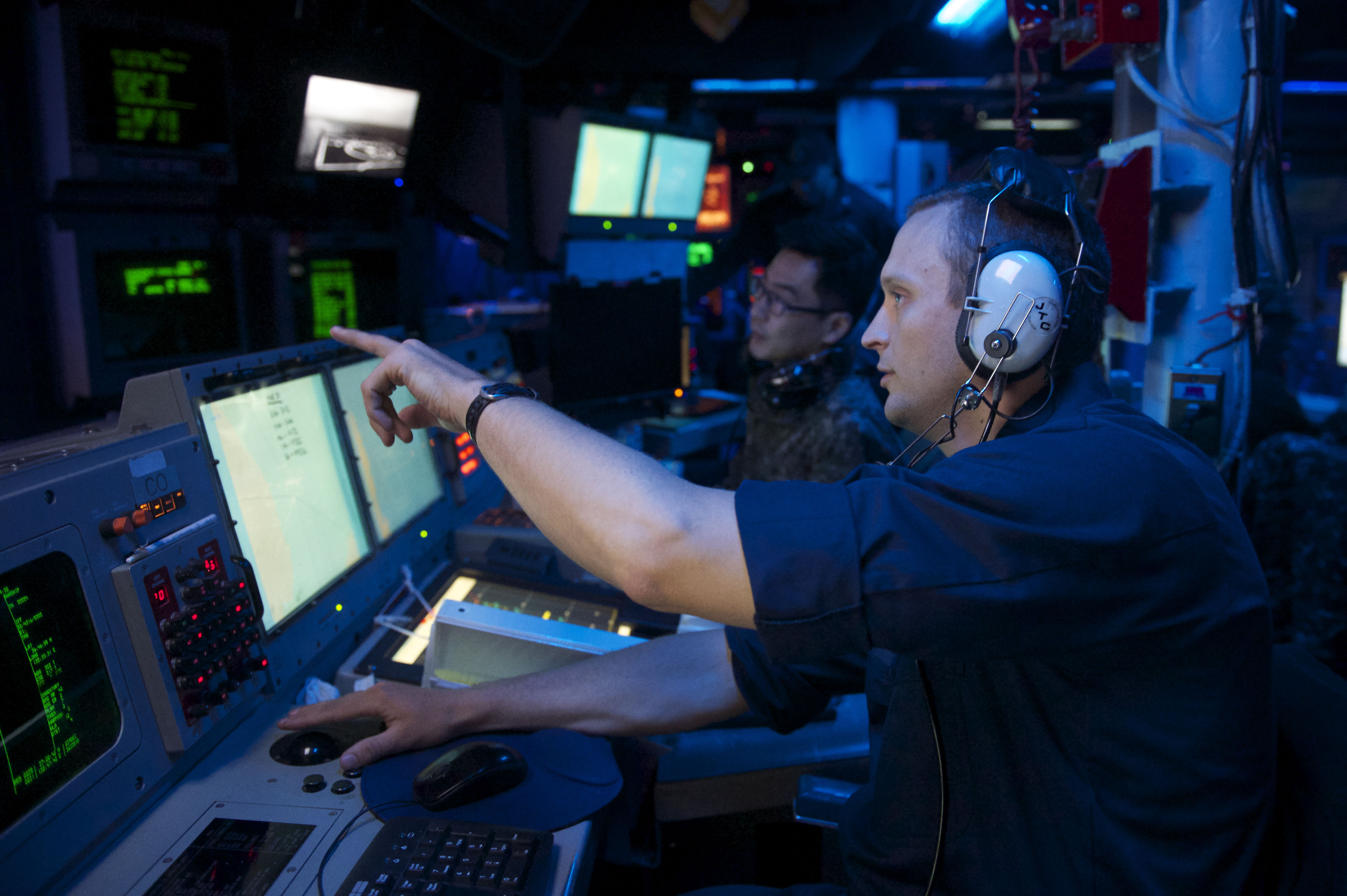 Lt. Richard Ray discusses the bi-lateral U.S. and Republic of Korea Navy's Surface Ship Anti-Submarine Warfare Readiness and Effectiveness Measure (SHAREM) exercise with Lt. Hyeoung Seok Noh, Republic of Korea Navy, in the combat information center aboard USS John S. McCain (DDG-56) on June 3, 2014. US Navy Photo