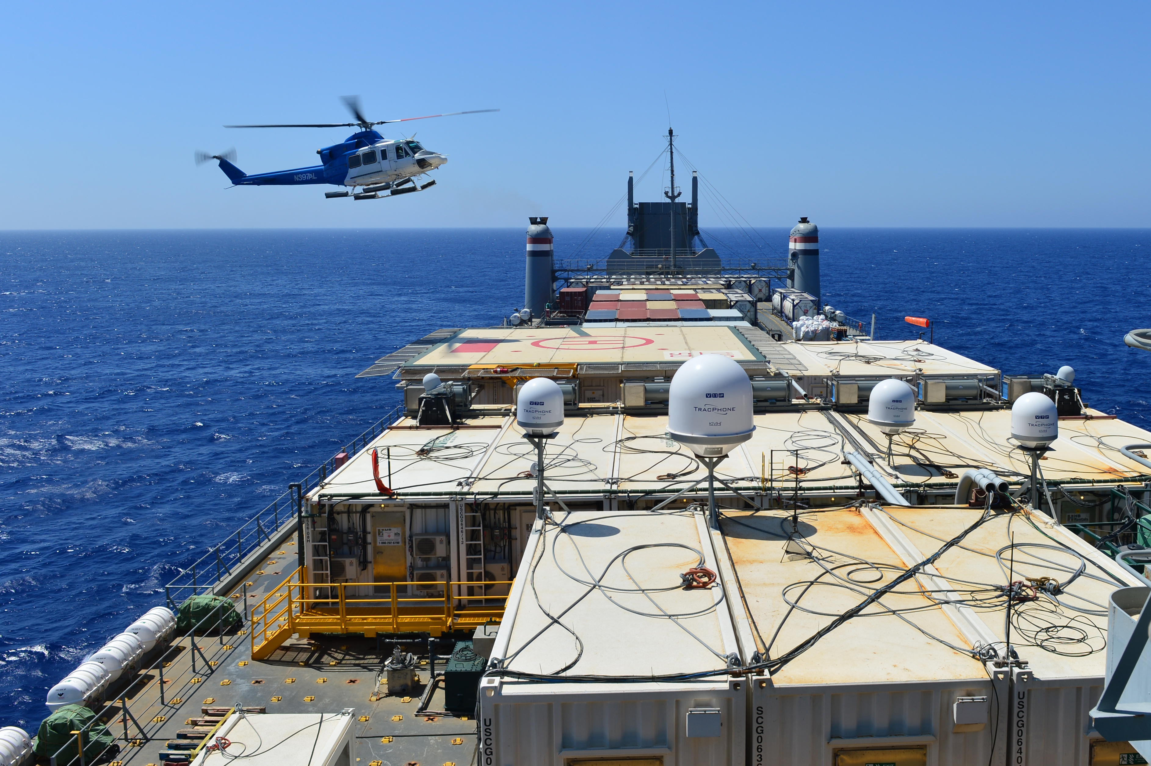 A helicopter approaches the container ship MV Cape Ray (T-AKR 9679) in the Mediterranean Sea to drop off cargo Aug. 4, 2014. US Navy Photo