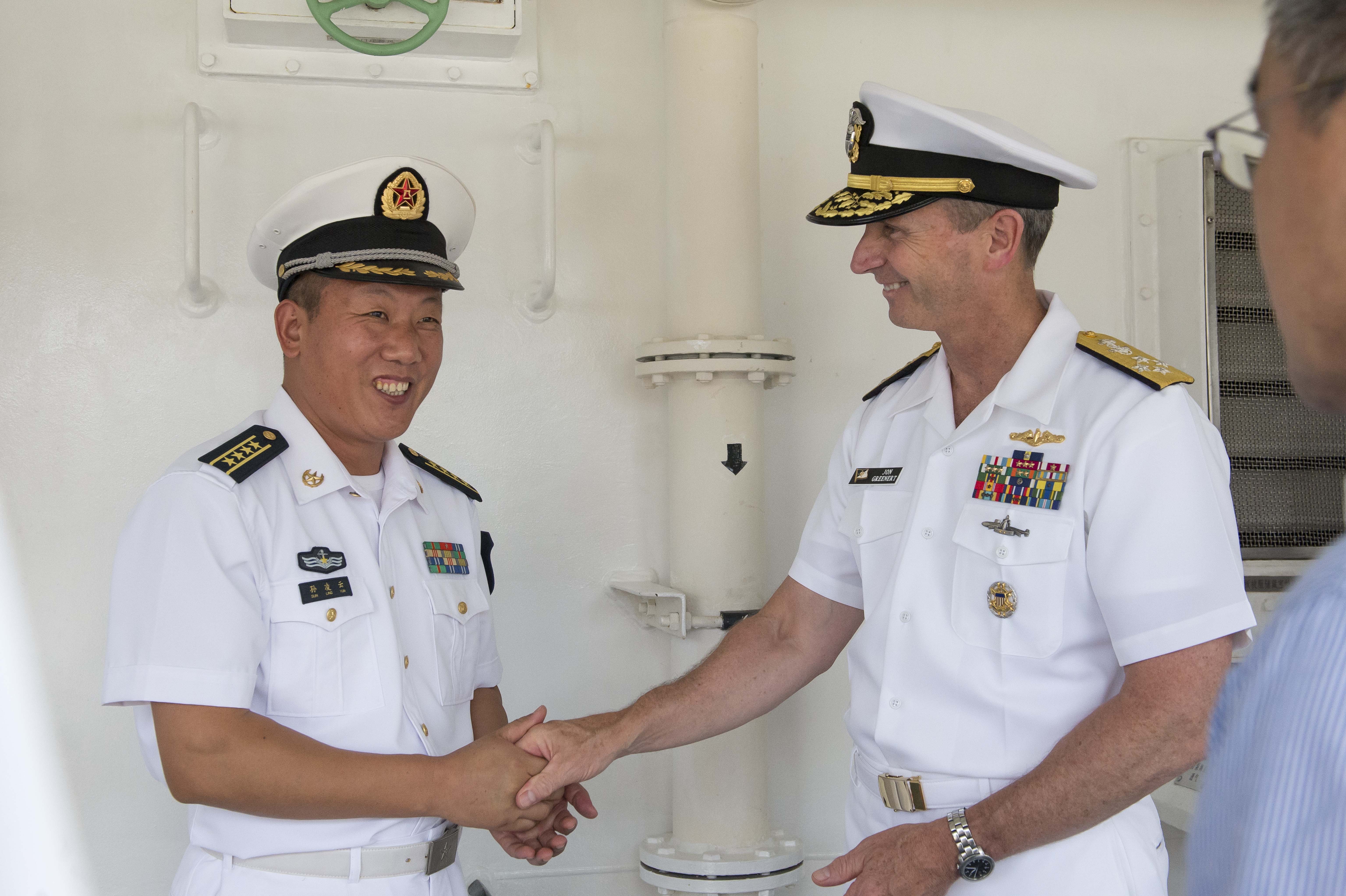 Adm. Jonathan Greenert thanks People's Liberation Army Navy (PLAN) Rear Adm. Sun Leng on July, 17 2014 in Dalian, China. US Navy Photo