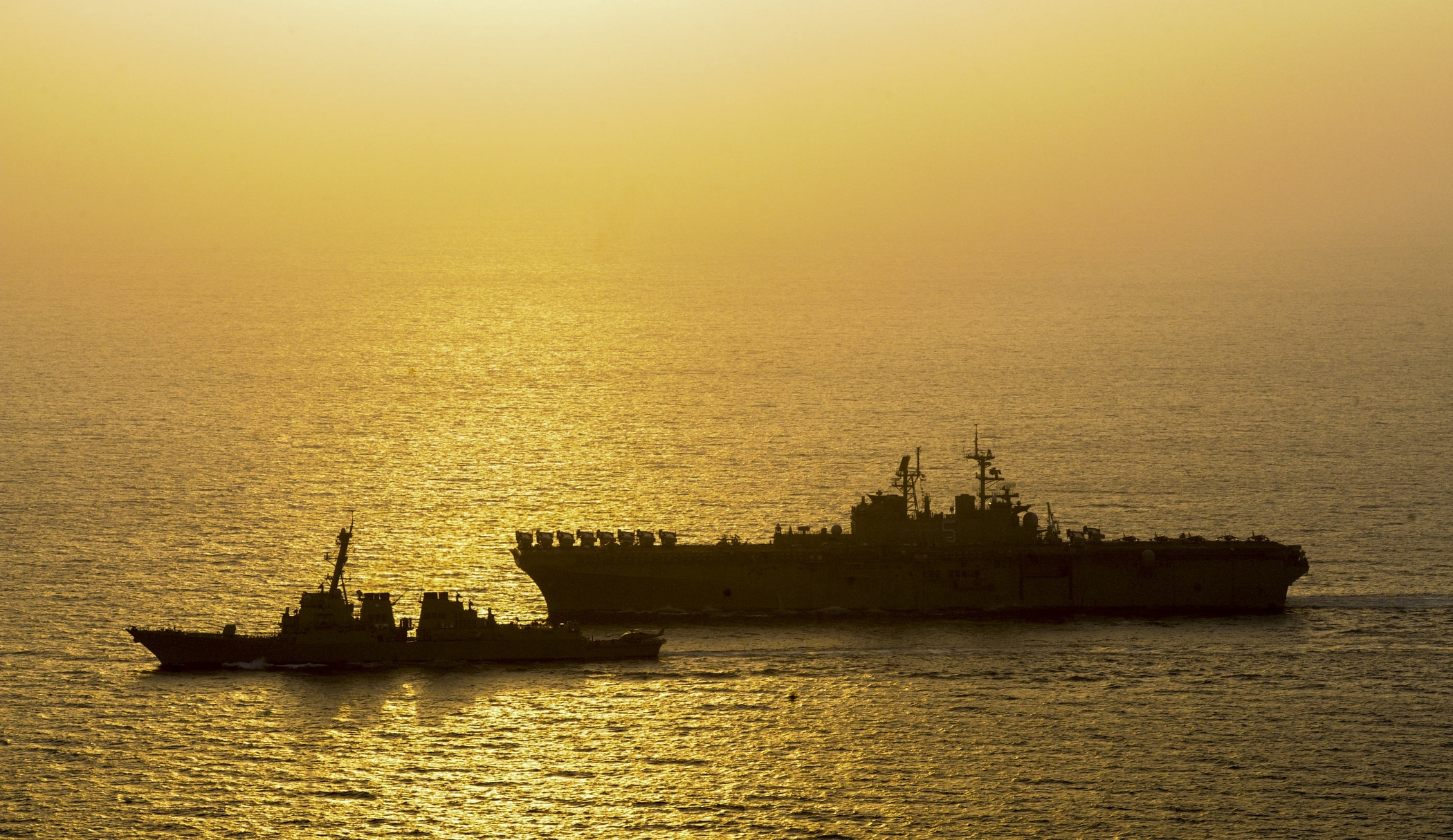 USS Roosevelt (DDG 80), left, and the amphibious assault ship USS Bataan (LHD 5) transit the Persian Gulf on Sept. 22, 2014. US Navy Photo