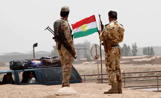 Members of the Kurdish security forces stand at a checkpoint during an intensive security deployment on the outskirts of Kirkuk June 11, 2014. Reuters Photo