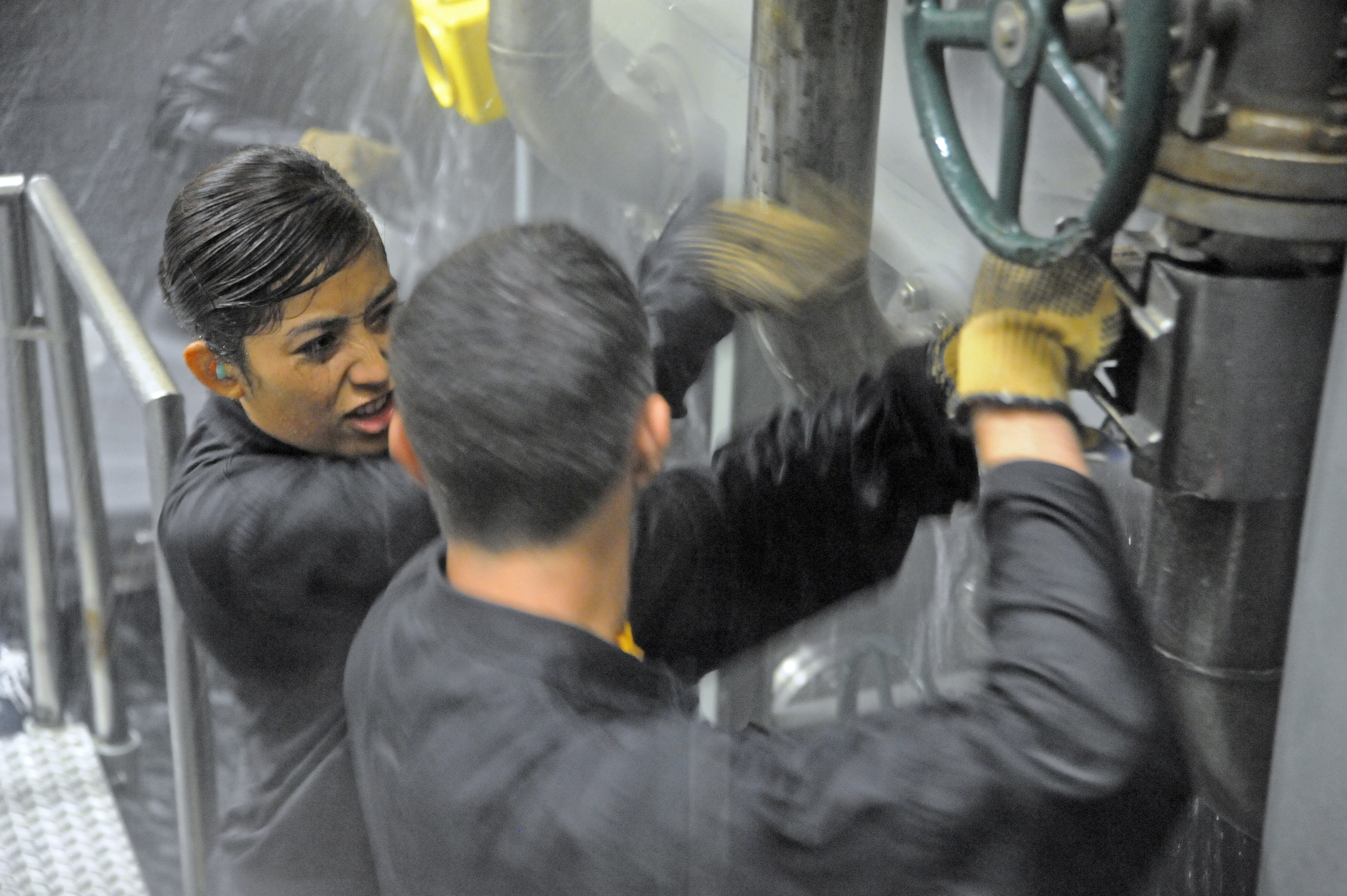 Midshipmen Janeth Jimenez and Dylan Brockin the damage control team wet trainer at Submarine Learning Center Detachment San Diego on June 6, 2013. US Navy Photo