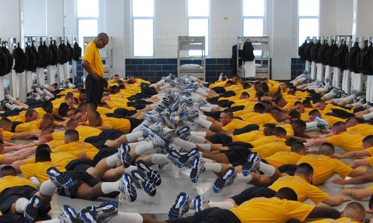 Seaman recruits perform physical training exercises in their berthing compartment at Recruit Training Command (RTC) on July 25, 2014. US Navy Photo
