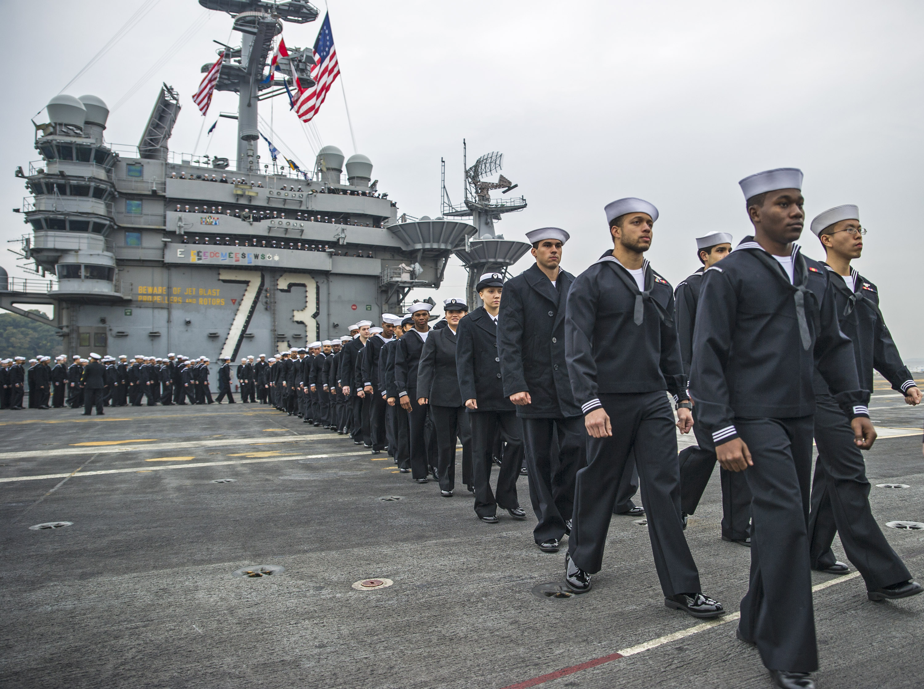 Sailors prepare to man the rails on the flight deck of the Nimitz-class aircraft carrier USS George Washington (CVN-73) on Nov. 25, 2014. US Navy Photo