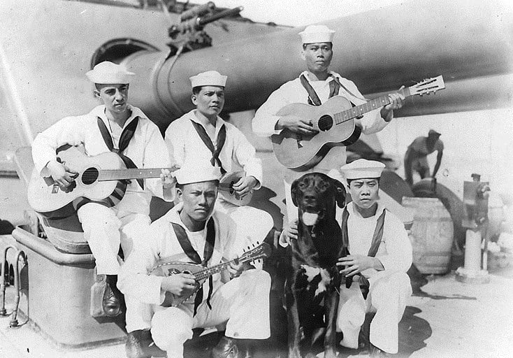 Filipino Stewards and their mascot on USS Seattle during WWII. Dogs were popular mascots in all the U.S. sea services.