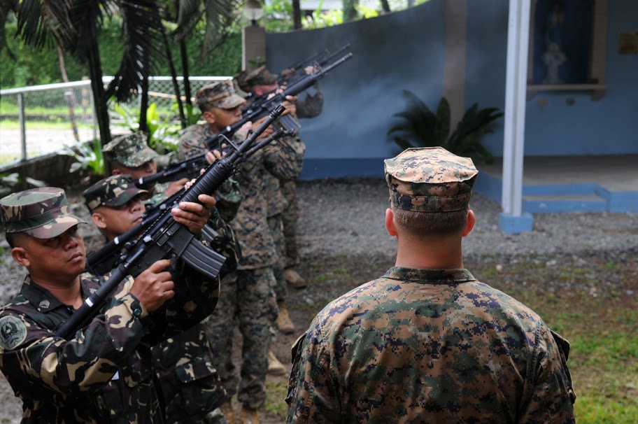 U.S. and Armed Forces of the Philippines (AFP) honor guard perform a 21-gun salute during a memorial service in Zamboanga City, Philippines in 2010. US Navy Photo 