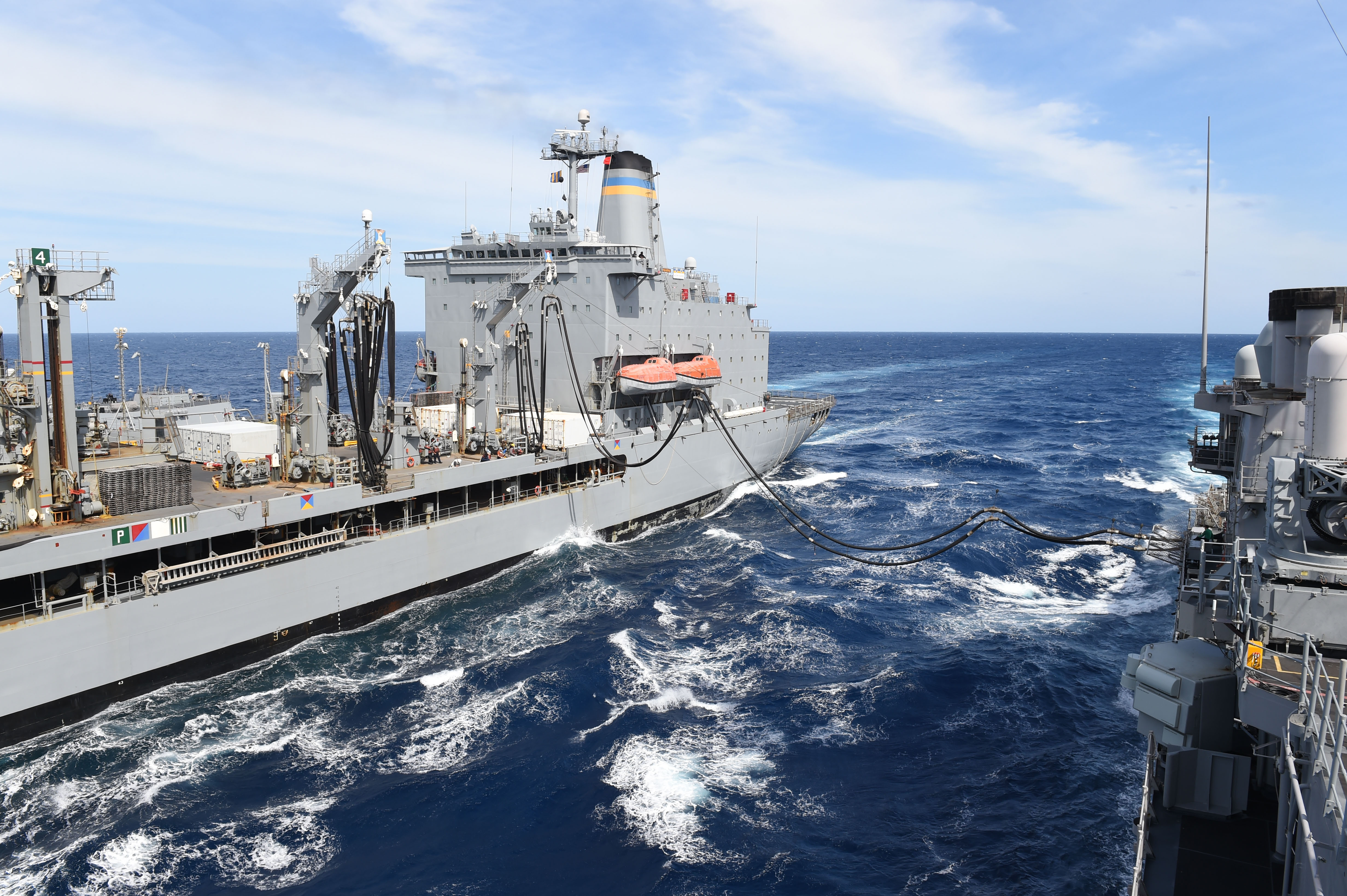 The guided-missile cruiser USS Vicksburg (CG-69) conducts a replenishment-at-sea with the Military Sealift Command fleet replenishment oiler USNS Kanawha (TAO-196). US Navy Photo