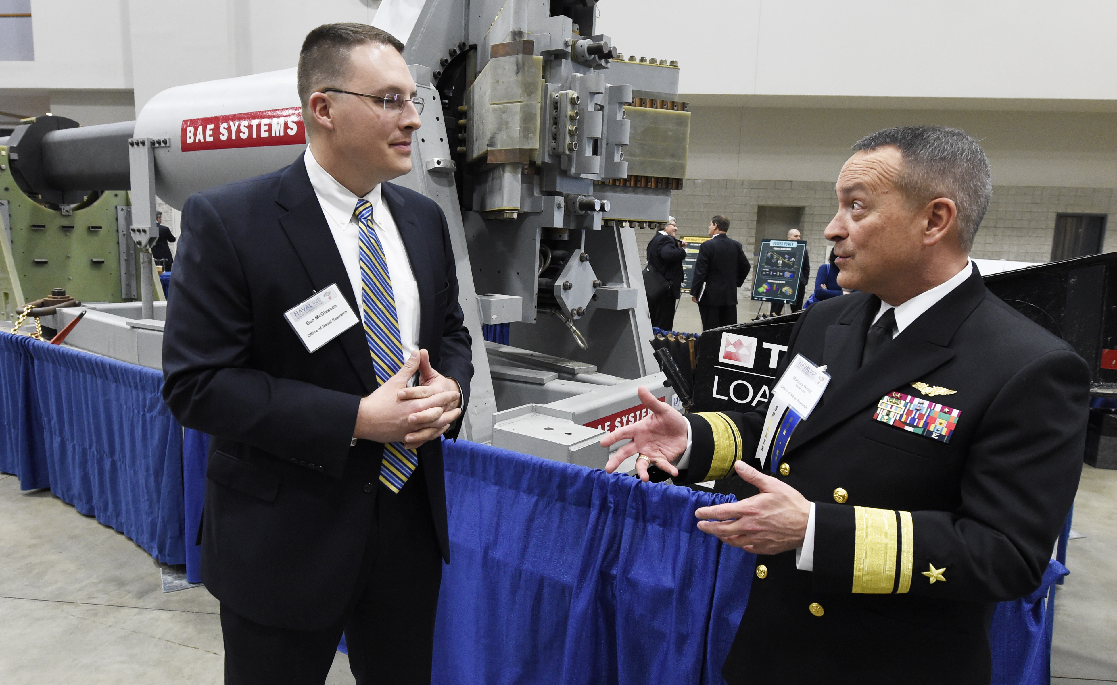 Ben McGlasson, a mechanical engineer for the Naval Surface Warfare Center Dahlgren Division, talks with Rear Adm. Mat Winter, chief of naval research on Feb. 4, 2015. US Navy Photo