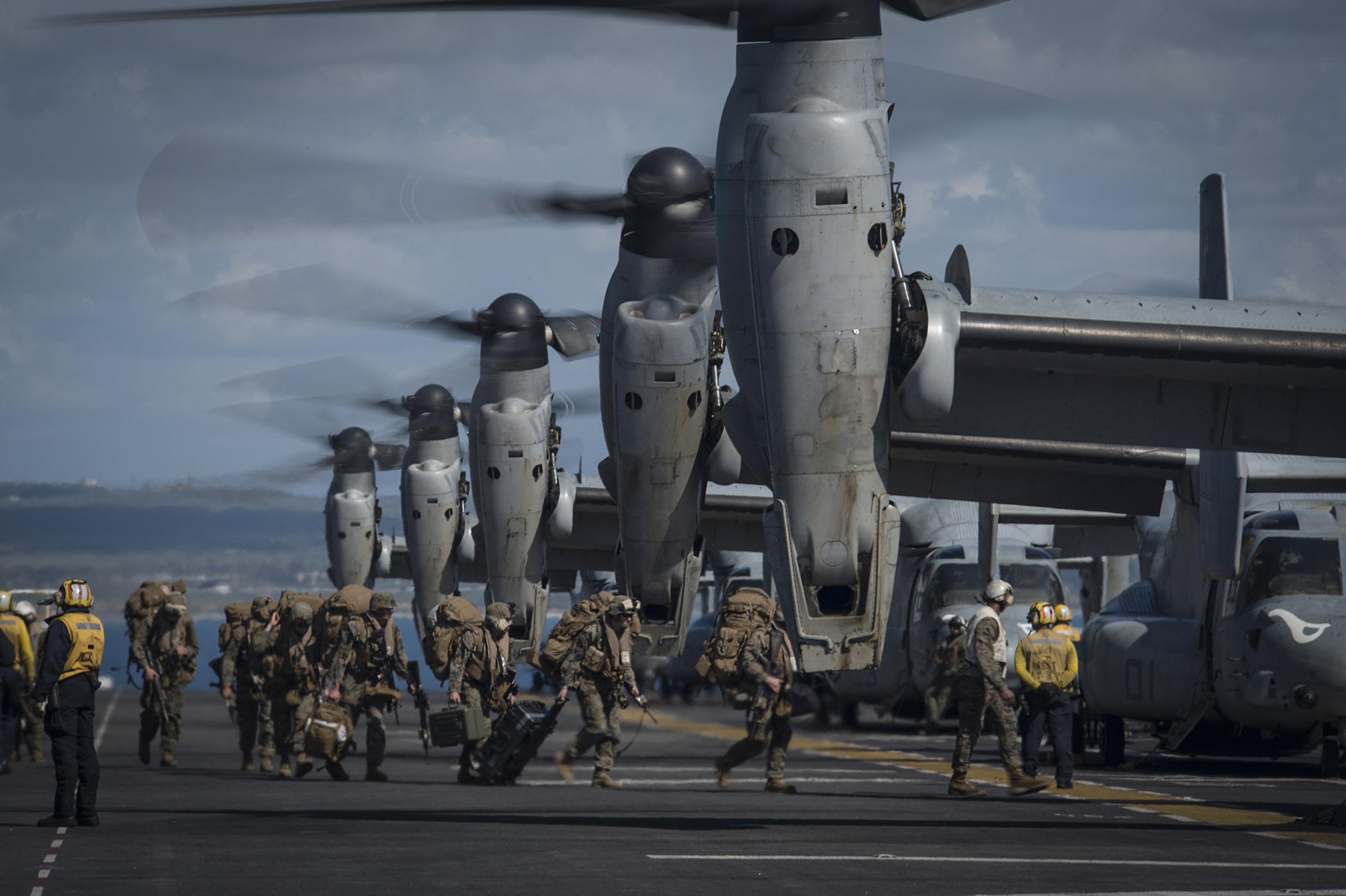 Marines from the 11th Marine Expeditionary Unit (11th MEU) board MV-22 Ospreys attached to Marine Medium Tiltrotor Squadron 163 (Reinforced) as they prepare to launch from the flight deck of the amphibious assault ship USS Makin Island (LHD-8) on Feb. 23, 2015. US Navy Photo