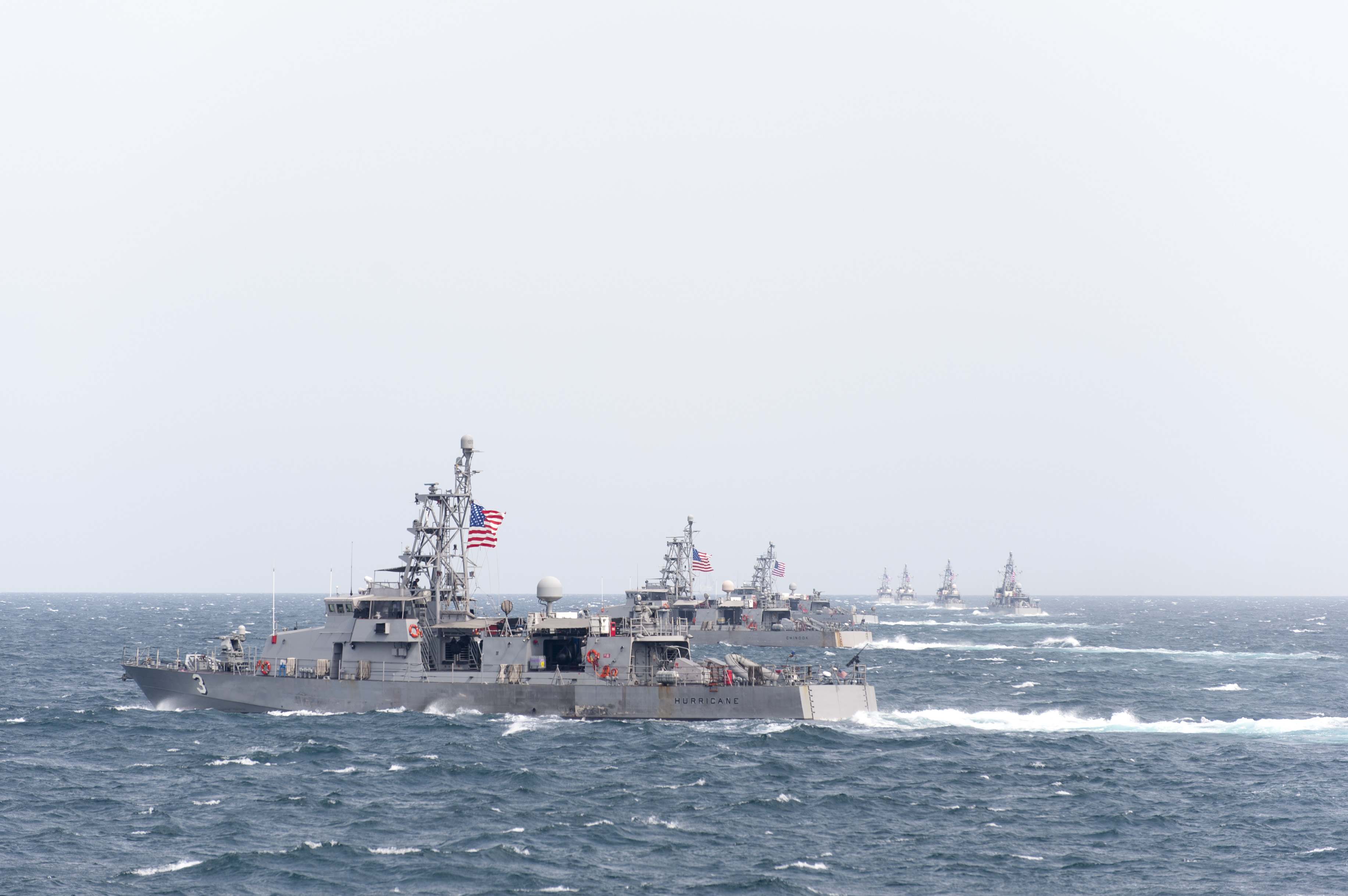 Cyclone-class coastal patrol ship USS Hurricane (PC 3) and other coastal patrol ships assigned to Patrol Coastal Squadron 1 (PCRON 1) transit in formation during a divisional tactics exercise.PCRON 1 is deployed. 