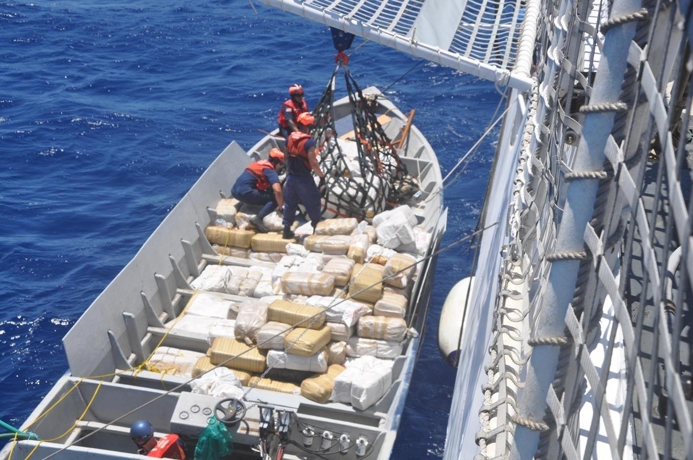 Coast Guardsmen from the Coast Guard Cutter Stratton from Alameda, Calif., unload narcotics from a smuggling vessel intercepted by the crew in the Eastern Pacific Ocean July 30, 2014. US Coast Guard Photo