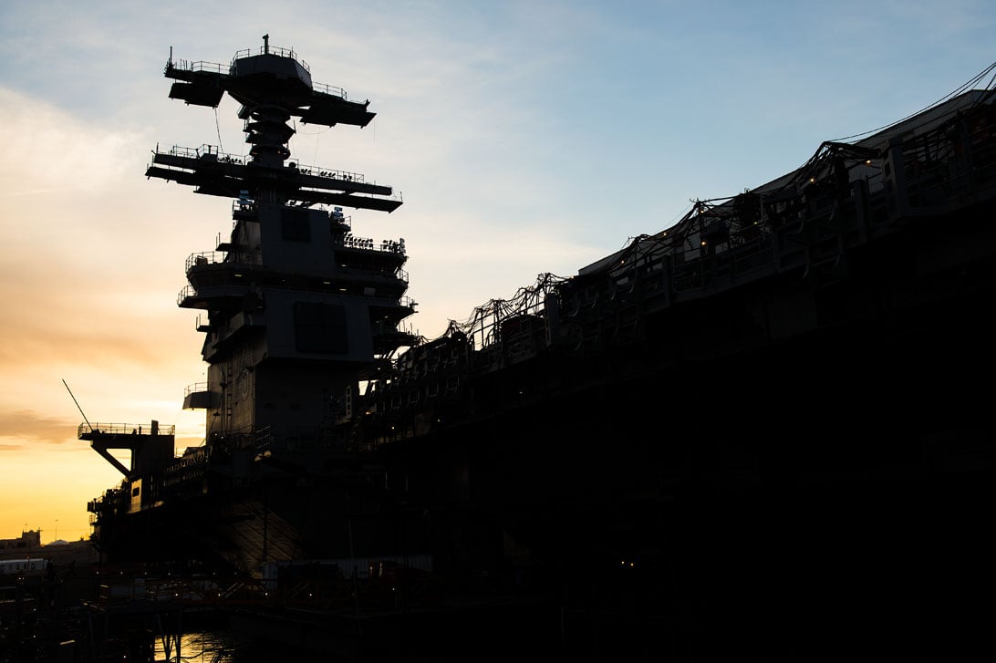 Aircraft carrier Gerald R. Ford (CVN-78) sits pier side in the early morning light at Newport News Shipbuilding in 2014. US Navy Photo