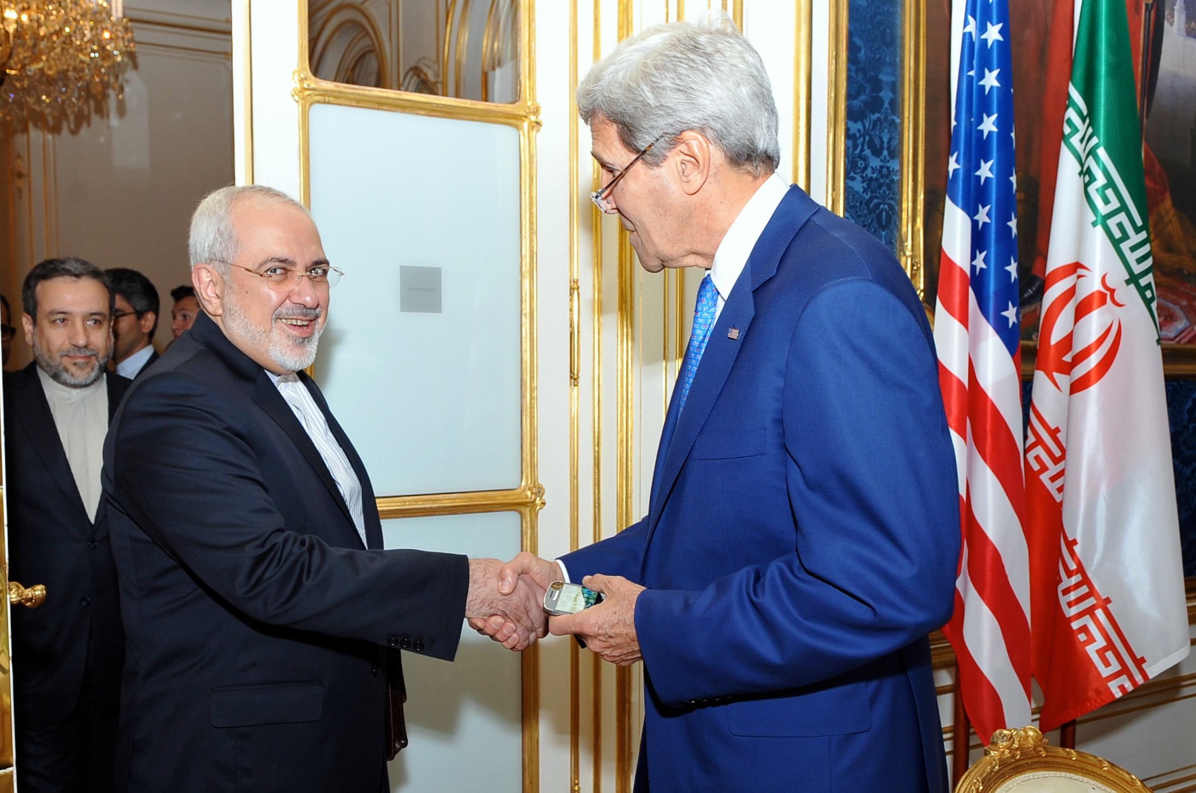 U.S. Secretary of State John Kerry shakes hands with Iranian Foreign Minister Mohammad Javad Zarif as he arrives at a hotel in Vienna, Austria, on July 14, 2014, for a second day of meetings about the future of his country's nuclear program. US State Dept. Photo